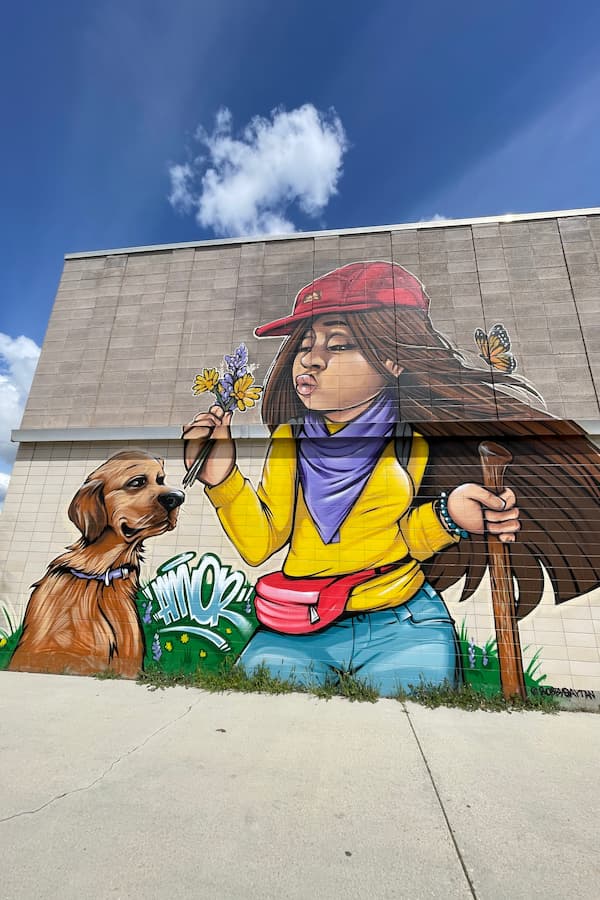 A Mural at the Old Boise Bus Station depictiing a person and a dog