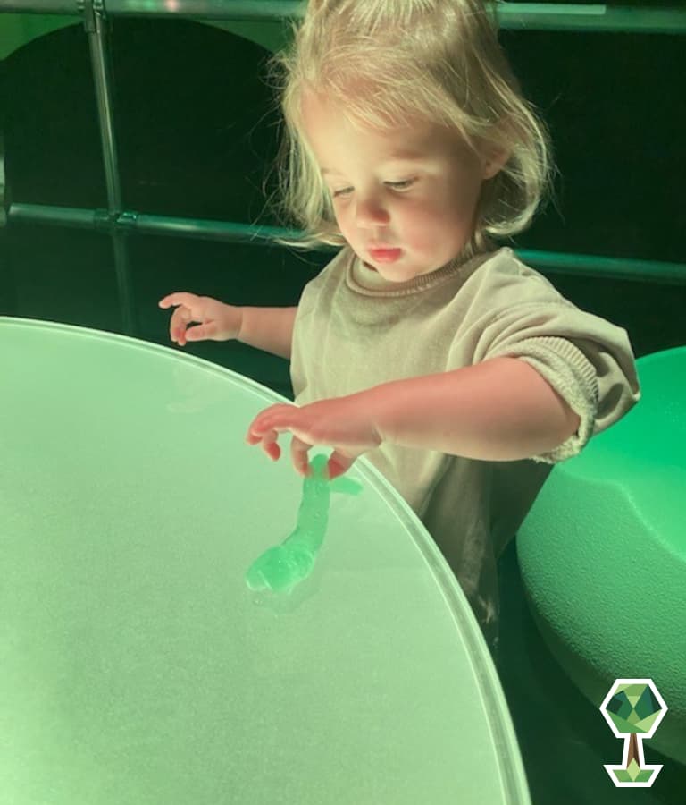 Kid playing with green slime | Totally Boise Indoor Activities Discovery Center