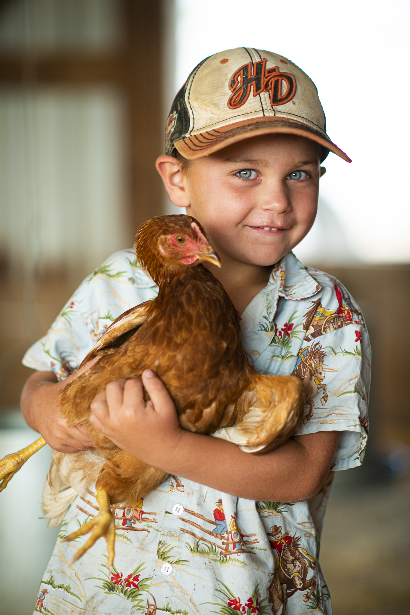 A child holding a chicken